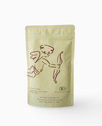 organic baking matcha powder in resealable pouch with cherub illustration on white background