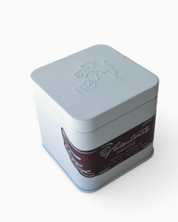 ceremonial blue metal tin with embossed design on a white background