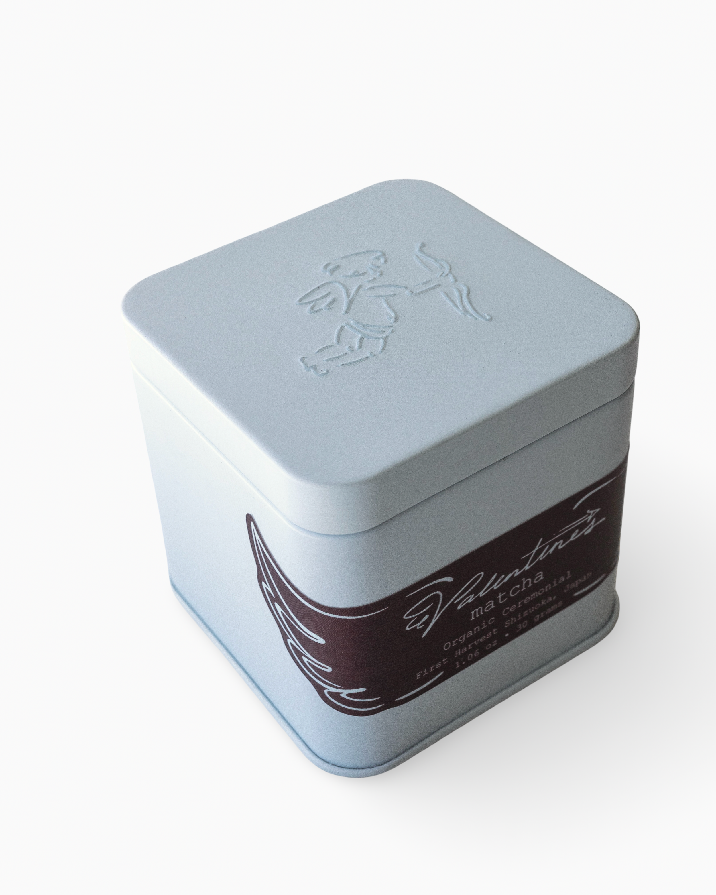 ceremonial blue metal tin with embossed design on a white background